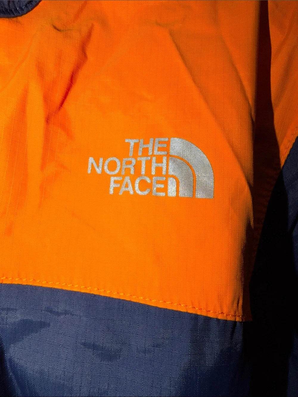 The North Face Kids Navy Blue and Orange Raincoat